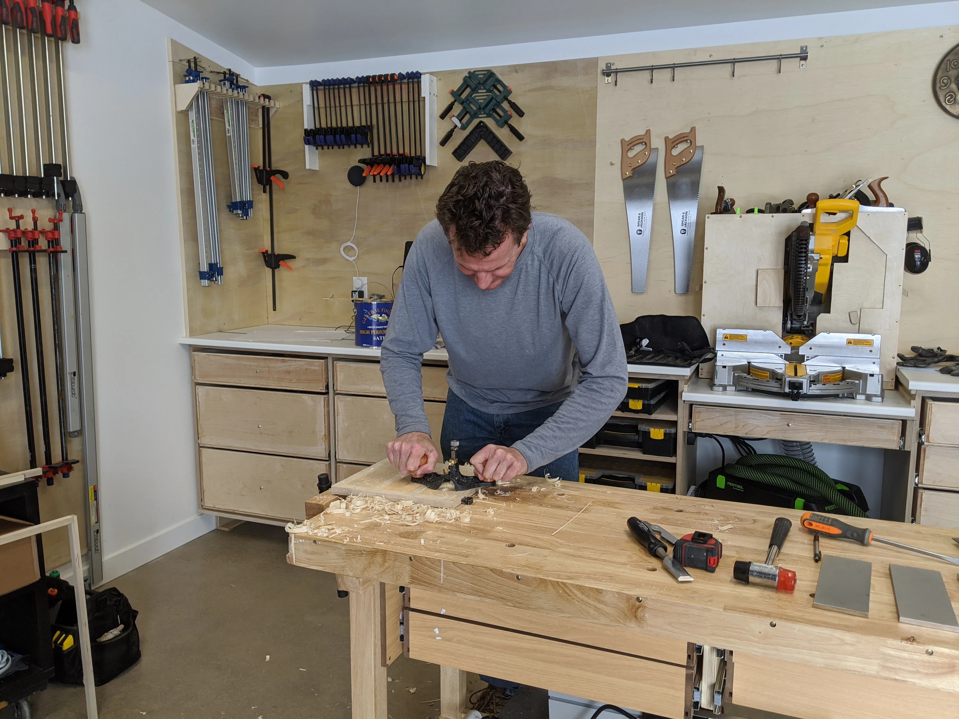 Martijn working with a router plane on a piece of wood